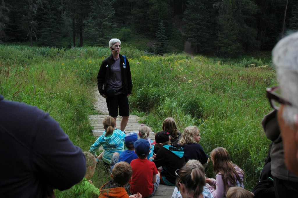 Children sit and listen, spellbound, as Mimi tells tales of mysterious happenings in the Cypress Hills. July 25, 2015. Kristin Catherwood